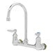 A chrome T&S wall mount faucet with two silver levers.