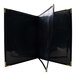 A black linen menu cover with gold corners.