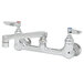 A T&S chrome wall mount pantry faucet with two handles and two faucets.