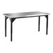 A rectangular National Public Seating utility table with a black steel base and stainless steel top.