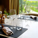 Arcoroc Serena wine glasses on a table with napkins.