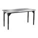 A National Public Seating stainless steel utility table with black legs.