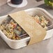 A compostable paper sleeve wrapped around a 60 oz. fiber food container with a clear lid.