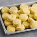 A tray of round, yellow cheese and jalapeno egg bites.