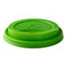 A green compostable plastic sip lid for hot cups.