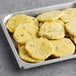 A tray of fully cooked, round jalapeno scrambled egg patties.