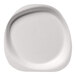 A close-up of a Jungle Stone compostable sugarcane pulp plate with a curved edge.