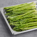 A tray of frozen medium asparagus spears.