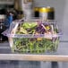 A salad in an Eco-Products clear plastic clamshell container.