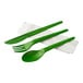 A green plastic wrapped cutlery pack with a green spoon, fork, and knife and a white napkin.