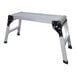 A portable aluminum work platform with four foldable legs and a ribbed surface.