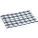 A folded navy and white gingham vinyl table cover with a flannel back.