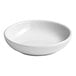 A small round white porcelain butter pad.