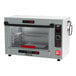 A silver and black Metro HotBlox Xpress small countertop heated holding cabinet with a rack of food inside.