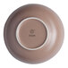 A white porcelain bowl with a brown rim and a small hole in the center.