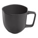 An Ariane charcoal grey porcelain mug with black dots and a handle.
