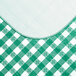 A green and white gingham-patterned vinyl table cover with a flannel back.