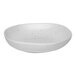 A white porcelain plate with specks.