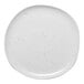 A white Ariane porcelain plate with speckled dots.