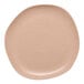 An Ariane Earth porcelain plate with dark sand dots on it.