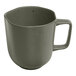 An Ariane mist green porcelain mug with grey dots and a handle.