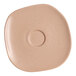 An Ariane Earth porcelain saucer with a brown speckled design.