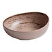 A brown bowl with a white speckled surface.