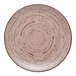 A close up of an Ariane Tornado dessert sage porcelain plate with a circular design.