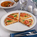 A round, warm white porcelain pizza plate with a narrow rim, holding four slices of pizza.