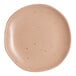 An Ariane Earth dark sand porcelain plate with speckles on it.