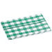 A folded green and white gingham vinyl table cover with a flannel back.