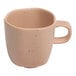 An Ariane dark sand porcelain espresso cup with speckled design.