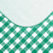 A green and white gingham vinyl table cover with a flannel back.