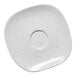 A white porcelain saucer with linen dots.