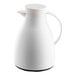 A white plastic coffee carafe with a handle and spout.