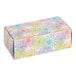 A rectangular cardboard candy box with a colorful floral pattern.