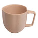 An Ariane dark sand porcelain cup with speckled dots.