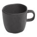 An Ariane charcoal grey porcelain espresso cup with black dots and a handle.
