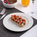 An 8 1/4-inch white round embossed wide rim flat porcelain plate.