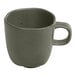 An Ariane mist green porcelain espresso cup with grey dots and a handle.