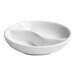 A round, warm white porcelain sauce dish with two divided compartments.