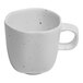 An Ariane white porcelain espresso cup with speckled dots.
