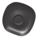 A charcoal grey Ariane porcelain saucer with dots in the center.