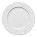 A round, wide-rimmed, warm white porcelain plate.