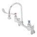 A T&S chrome wall mounted surgical sink faucet with two wrist action handles.