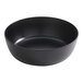 A large black round melamine serving bowl.