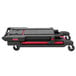 A black Rubbermaid rolling utility cart with red handles and wheels.