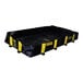 A black and yellow foldable spill containment berm designed for drive-over use.