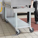 A stainless steel equipment stand with four caster wheels designed for easy mobility in commercial kitchens.
