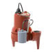 A red and black Liberty Pumps submersible sewage pump with a hose attached.